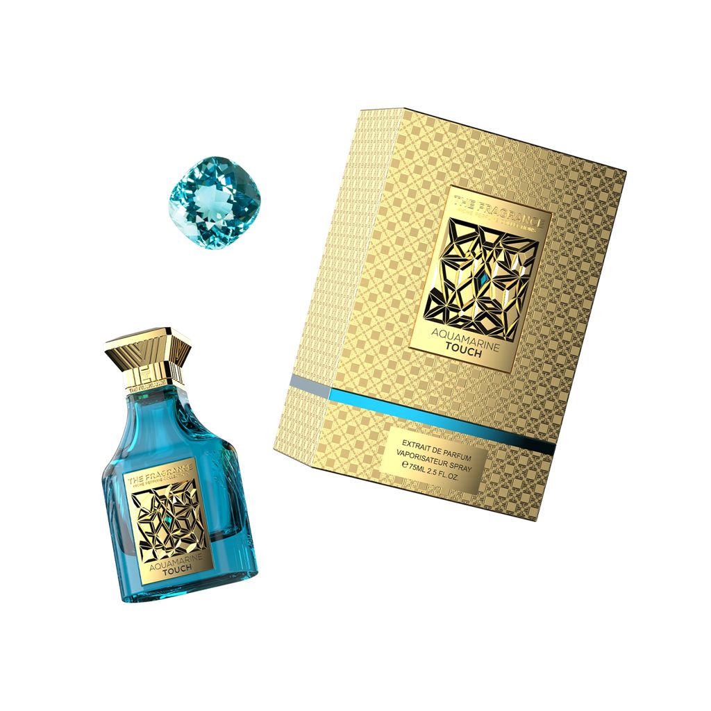 The Fragrance Aquamarine Touch Extrait de Parfum 75 ml – türkisfarbener Flakon schräg neben türkisem Aquamarin und goldener Box