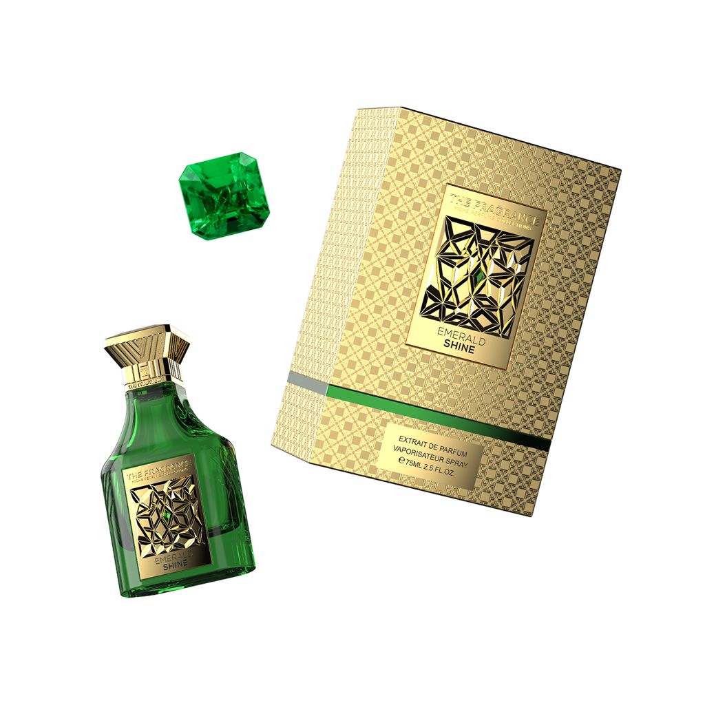 The Fragrance Emerald Shine Extrait de Parfum 75 ml – grüner Flakon schräg neben grünem Smaragd und goldener Box