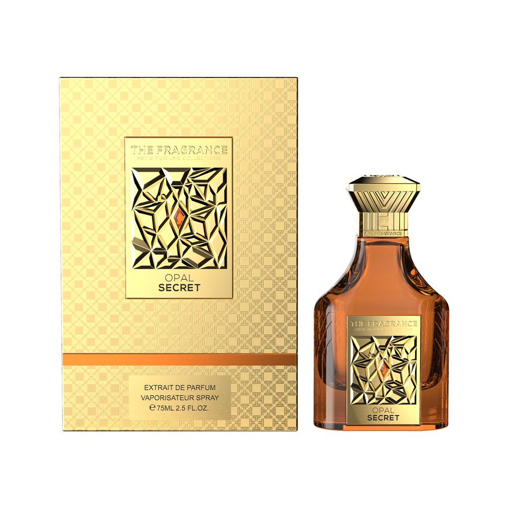The Fragrance Opal Secret Extrait de Parfum 75 ml – bernsteinfarbener Flakon rechts neben frontaler goldener Box mit orangem Streifen