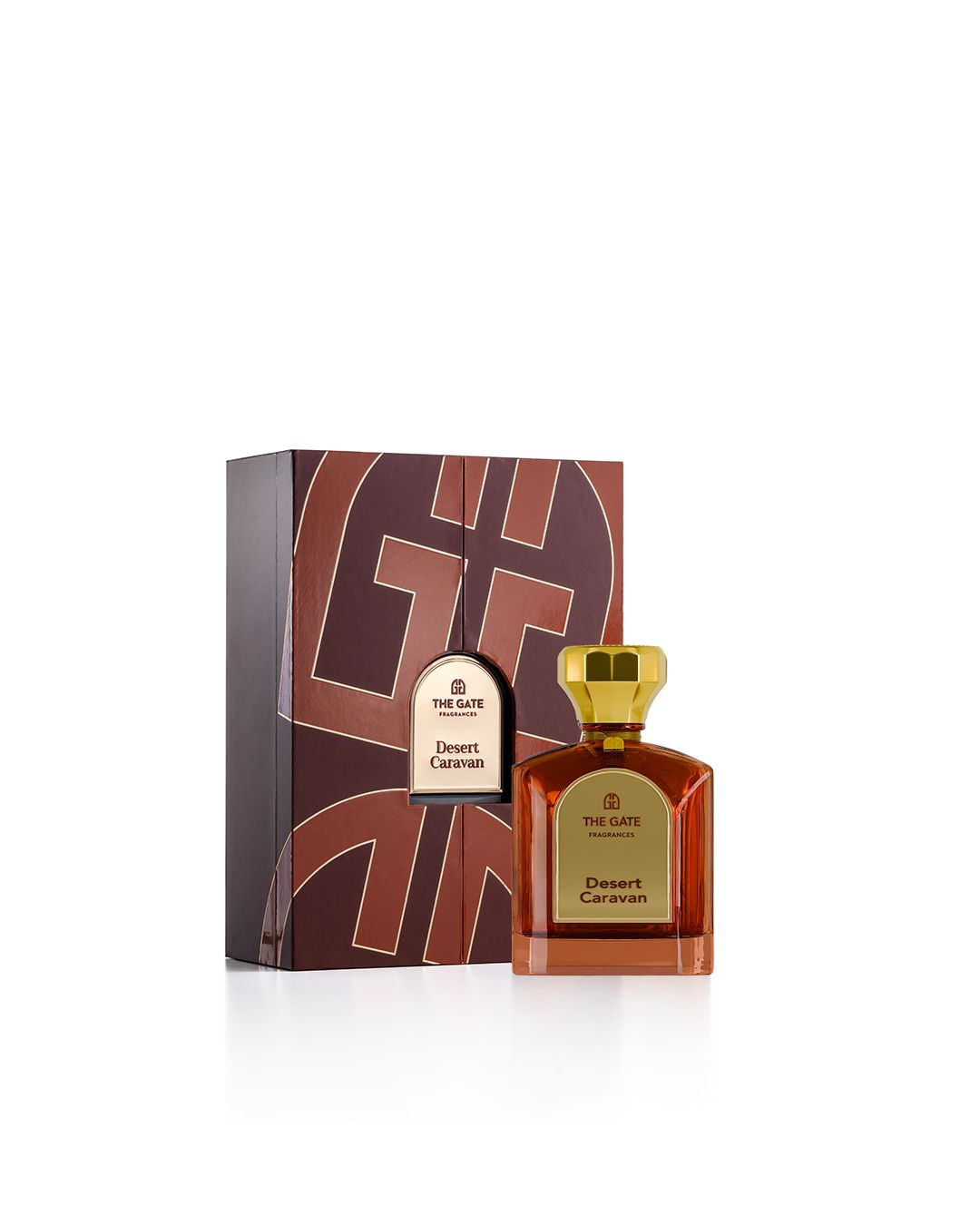The Gate Desert Caravan Extrait de Parfum 100 ml – bernsteinfarbener Flakon neben brauner Geschenkbox mit Logomuster