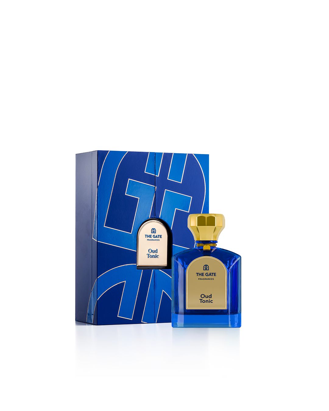 The Gate Oud Tonic Extrait de Parfum 100 ml – blauer Flakon neben blauer Geschenkbox mit Logomuster