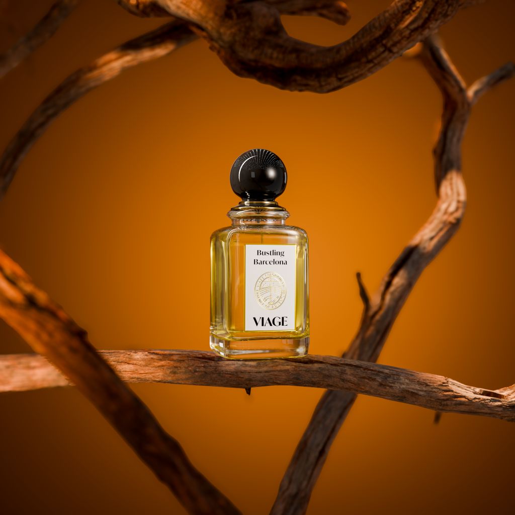 Viage Bustling Barcelona Extrait de Parfum 100 ml – Flakon auf knorrigem Holzast vor orangem Hintergrund